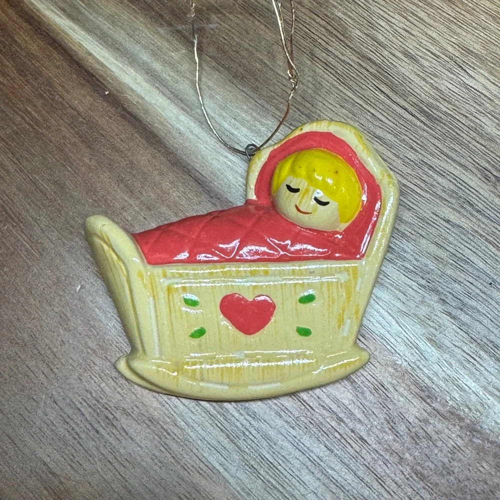 Vintage Handmade Korea Baby in Cradle Ornament Yellow Red Heart Rocking Bassinet
